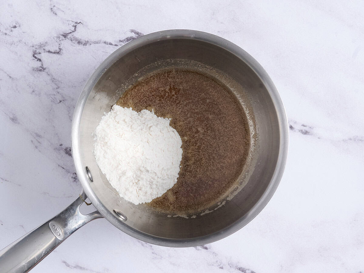 Flour added to browned butter in a sauce pan.